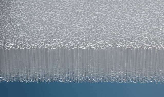 OKALUX capillary slab cross-section detail showing hollow tubes and glass fiber tissue layer