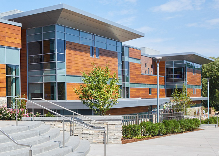 OKALUX Plus 26 school exterior — diffuse capillary daylighting on solar-loaded facade