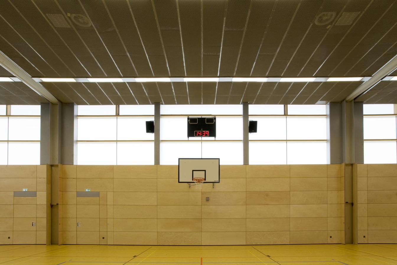 Sporthalle Traunreut interior — OKALUX capillary clerestory daylighting over basketball court