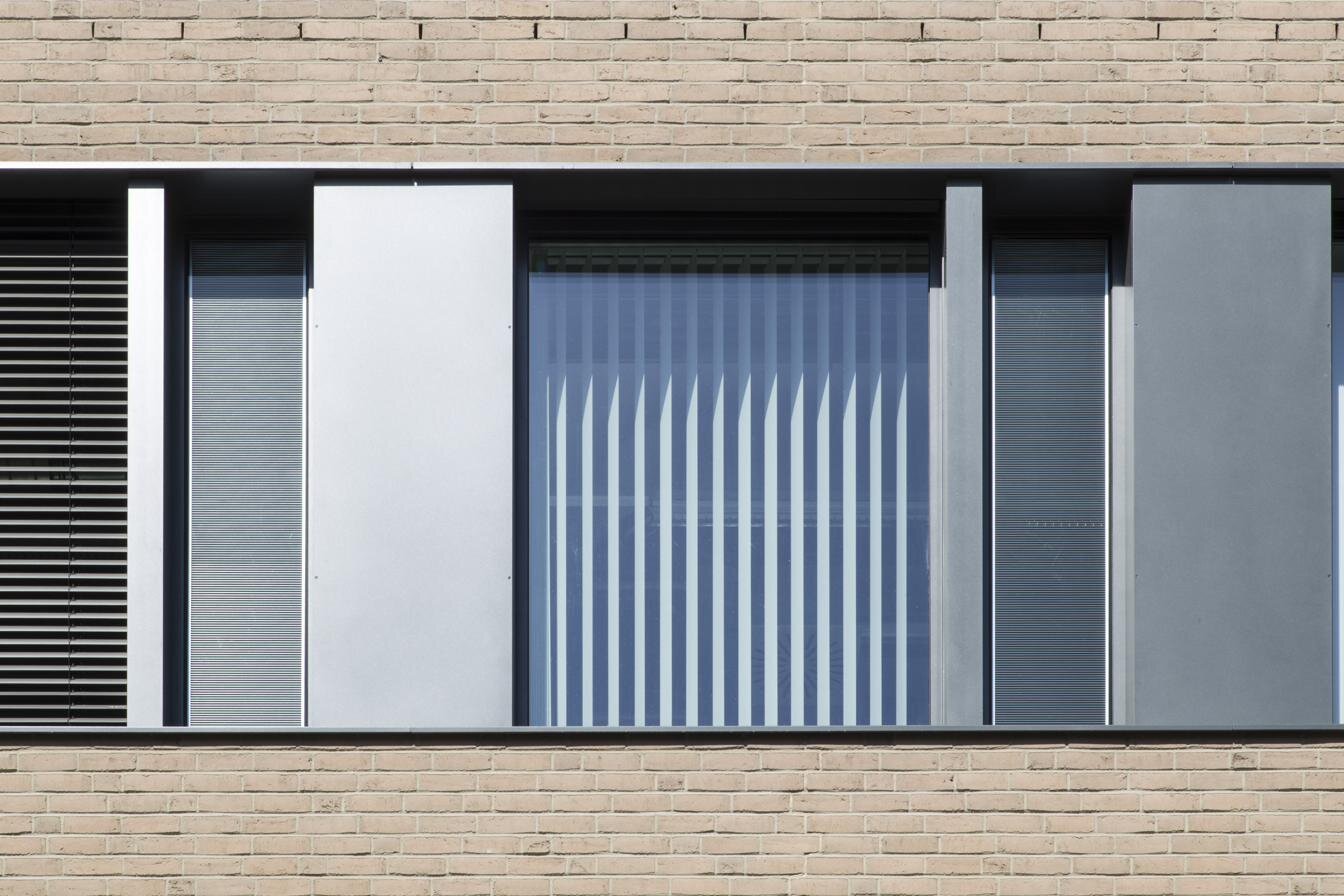 OKASOLAR F vertical louver grid visible through facade glazing at Magdeburg University laboratory building