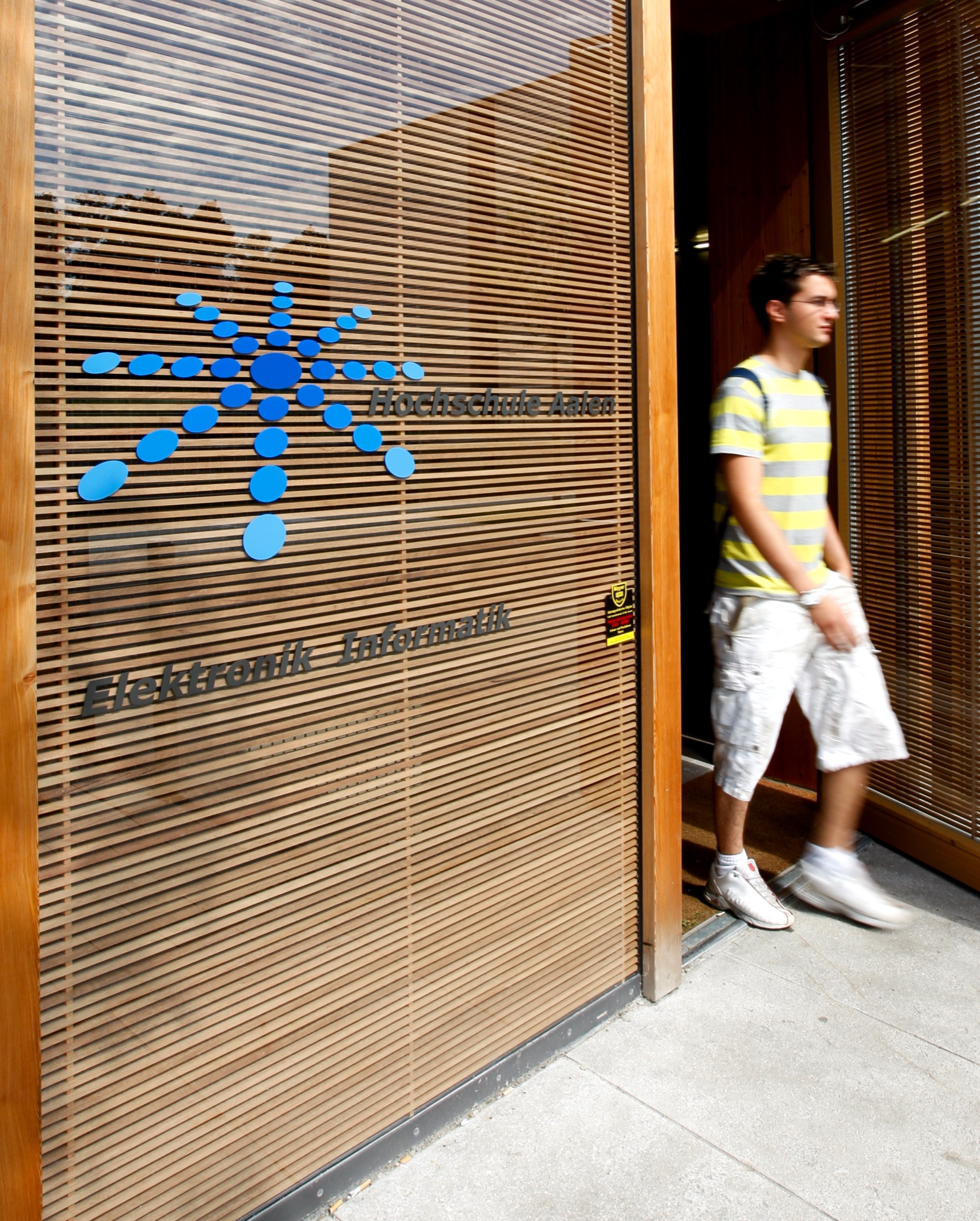Aalen Fachhochschule entry bay — OKAWOOD wood-rib panels with glazed signage entry