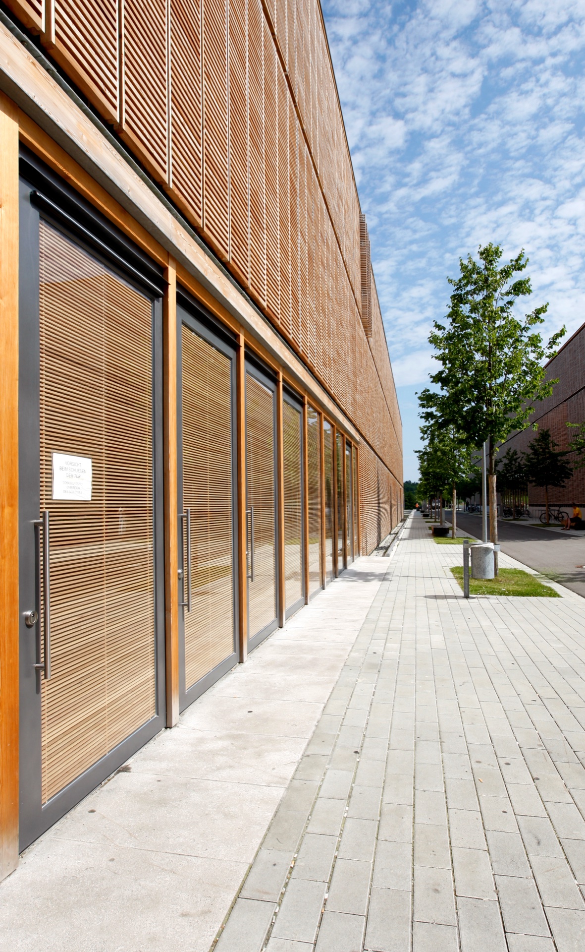 Aalen Fachhochschule west wing — OKAWOOD multi-story facade with horizontal wood ribs