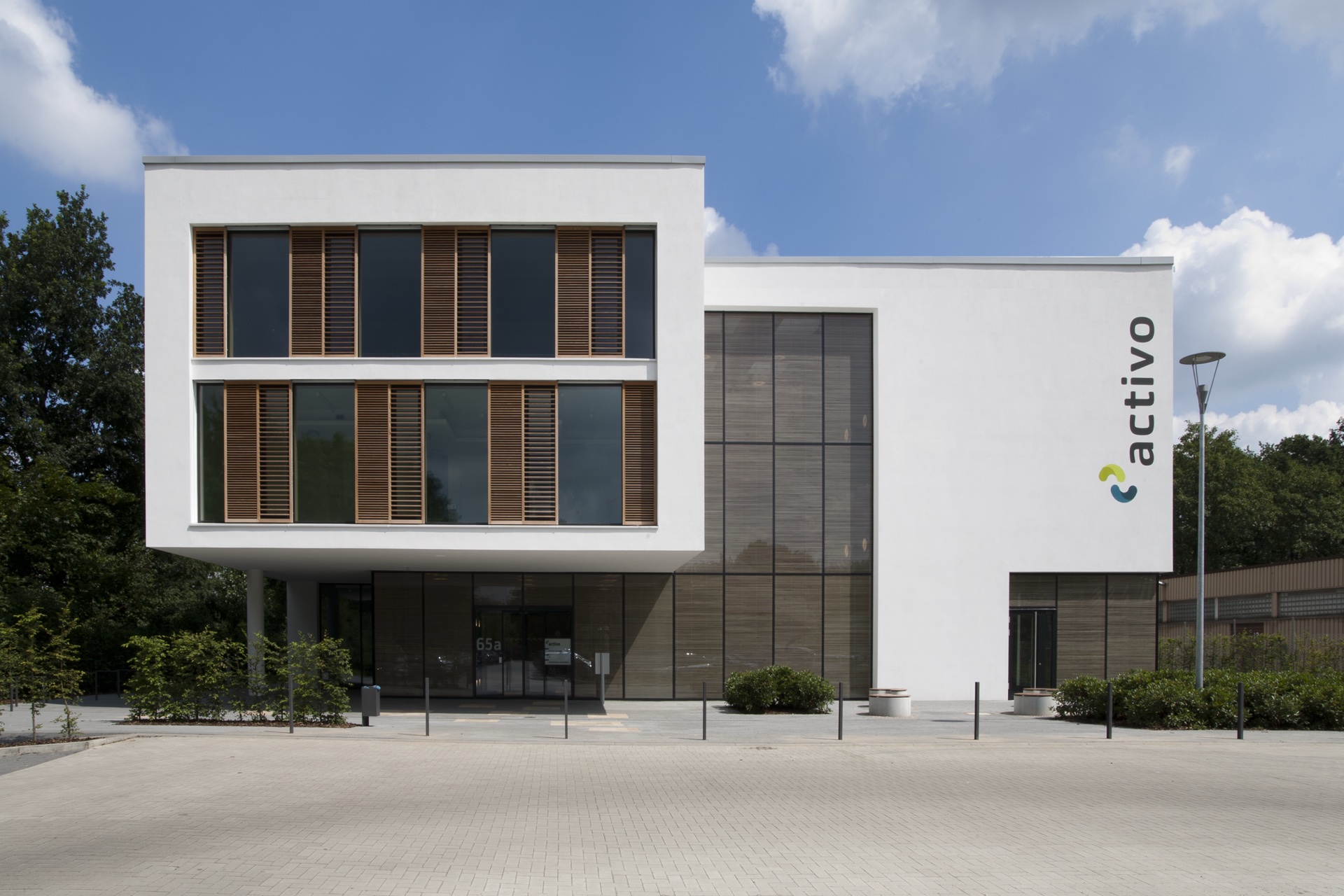 Bremen OKAWOOD building exterior — horizontal wood-rib IGU panels across facade